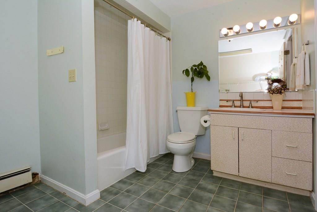 24 1st Street Amesbury, MA 01913 - Photo 32 of 42 a bathroom with a sink a toilet and mirror