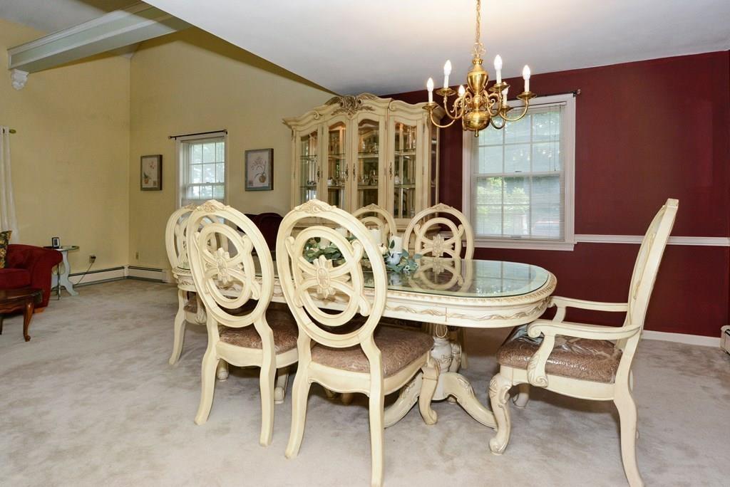 24 1st Street Amesbury, MA 01913 - Photo 5 of 42 a view of a dining room with furniture and chandelier