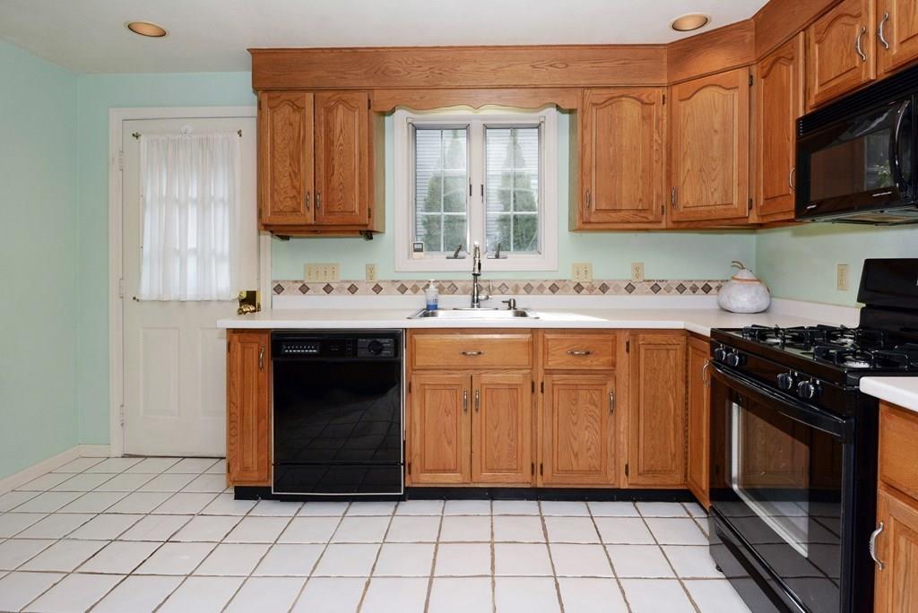 24 1st Street Amesbury, MA 01913 - Photo 10 of 42 a kitchen with stainless steel appliances a stove a sink and a microwave