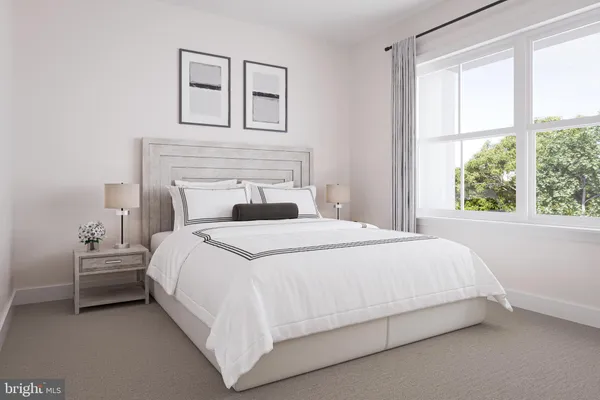 a bedroom with a bed and a large window