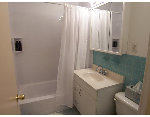 35 Glencoe Street, Unit 43 Boston, MA 02135 - Photo 11 of 19 a bathroom with a sink mirror and shower