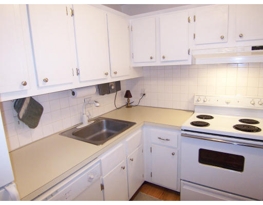 35 Glencoe Street, Unit 43 Boston, MA 02135 - Photo 12 of 19 a kitchen with white cabinets and white appliances