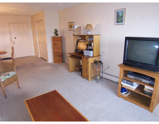 35 Glencoe Street, Unit 43 Boston, MA 02135 - Photo 7 of 19 a living room with furniture and a flat screen tv