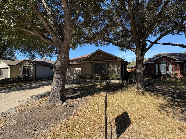 a front view of a house with a yard covered with snow