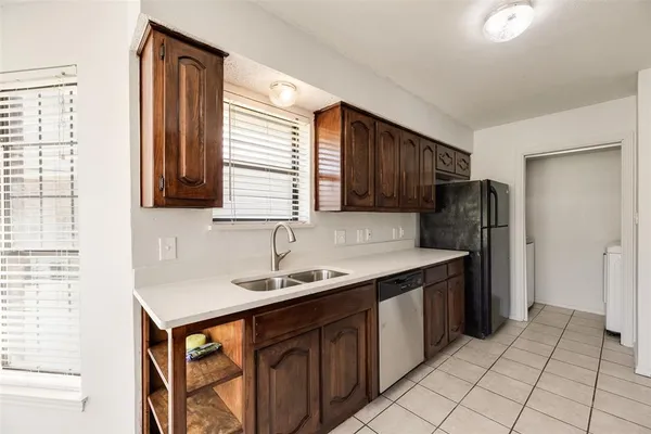 a kitchen with a refrigerator and a stove top oven