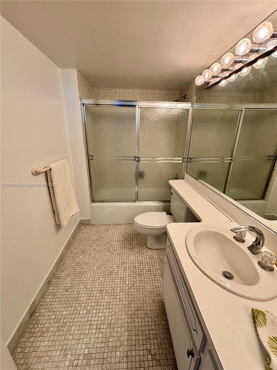 609 Ocean Drive, Unit 10H Key Biscayne, FL 33149 - Photo 15 of 21 a bathroom with a sink a toilet and shower