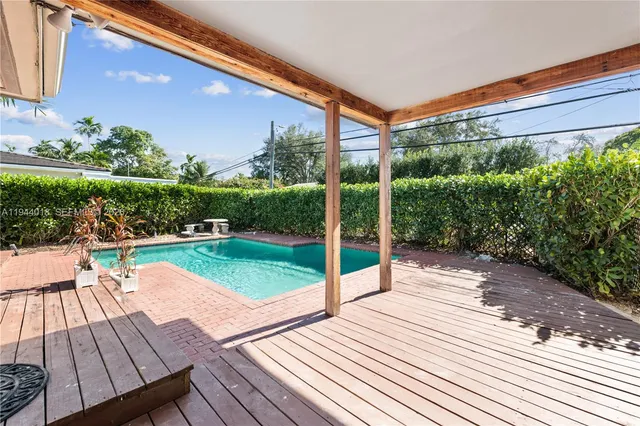 a patio with wooden floor and outdoor seating