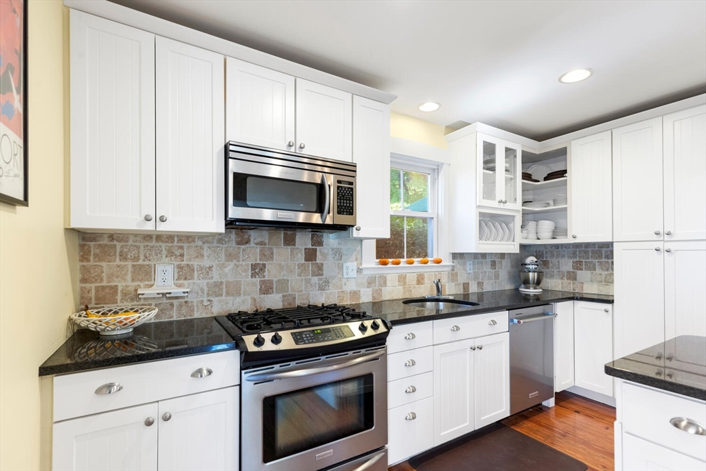 100 Willow Street Hamilton, MA 01982 - Photo 14 of 35 a kitchen with stainless steel appliances granite countertop white cabinets sink and stove
