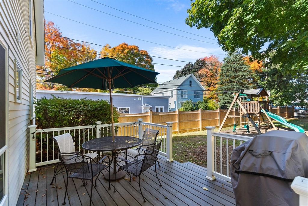 100 Willow Street Hamilton, MA 01982 - Photo 30 of 35 a view of deck with table and chairs under an umbrella with wooden floor