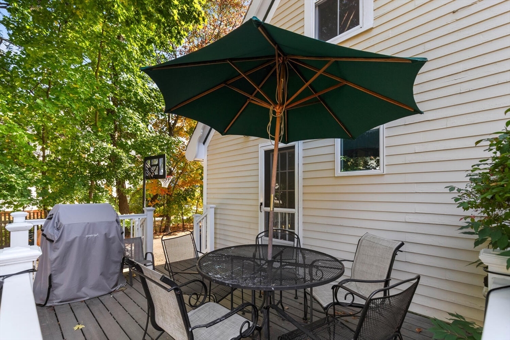 100 Willow Street Hamilton, MA 01982 - Photo 31 of 35 a patio with a table and chairs under an umbrella