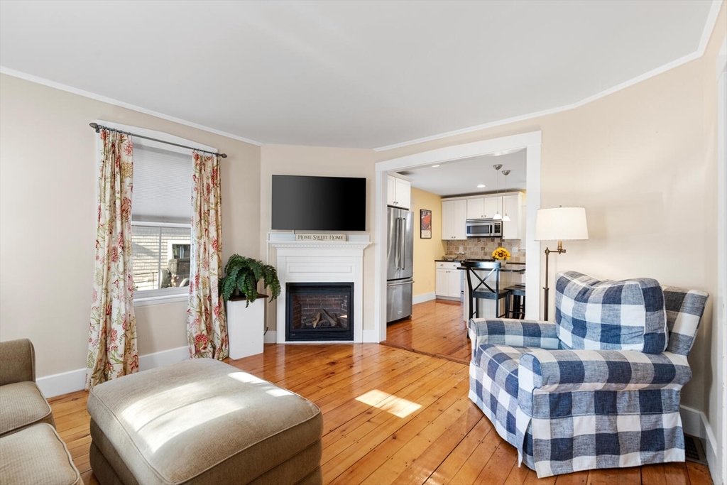 100 Willow Street Hamilton, MA 01982 - Photo 8 of 35 a bedroom with a bed and a fireplace