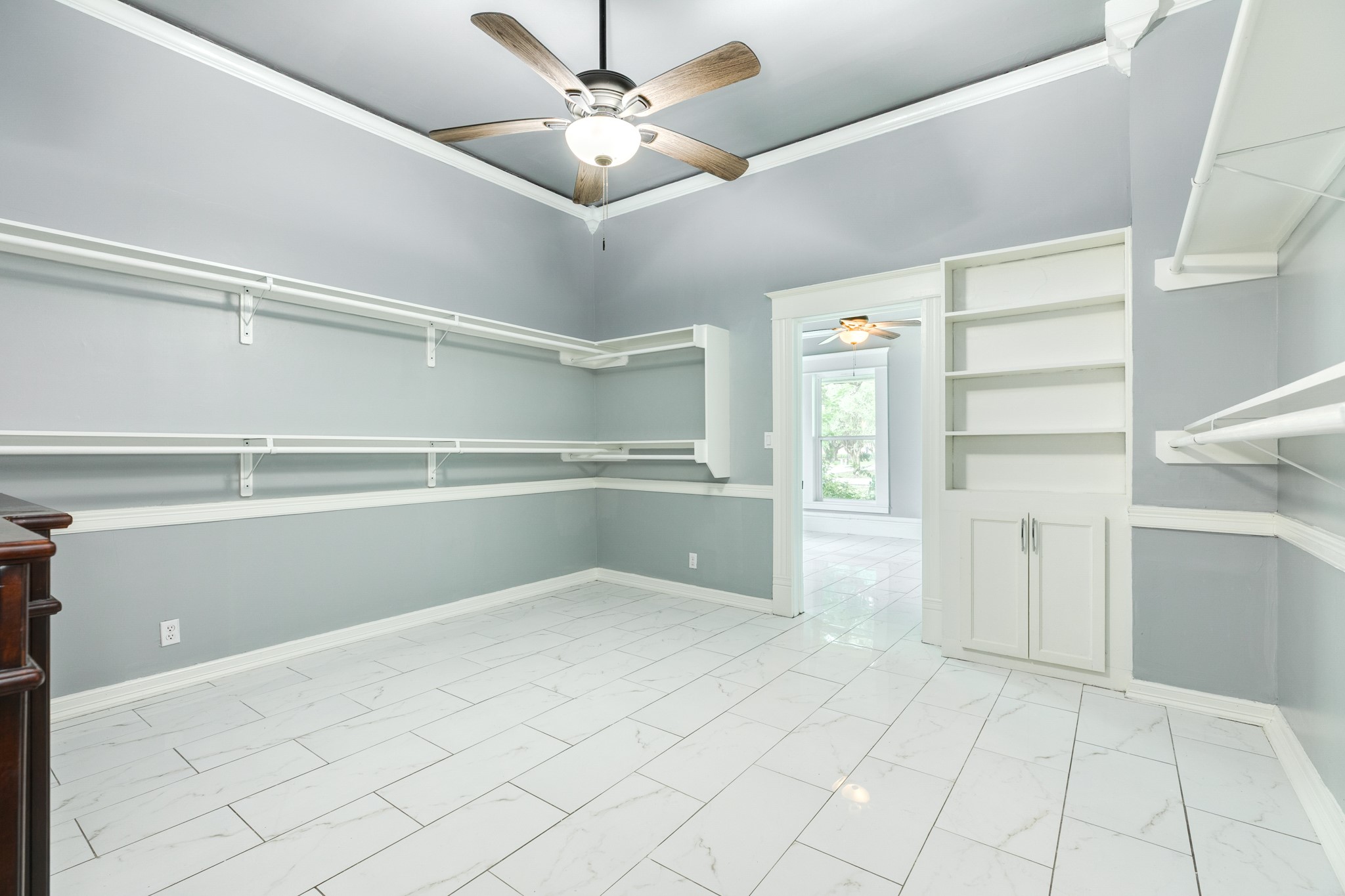 336 North Rockisland Street Angleton, TX 77515 - Photo 18 of 32 a view of an empty room with cabinet and a ceiling fan