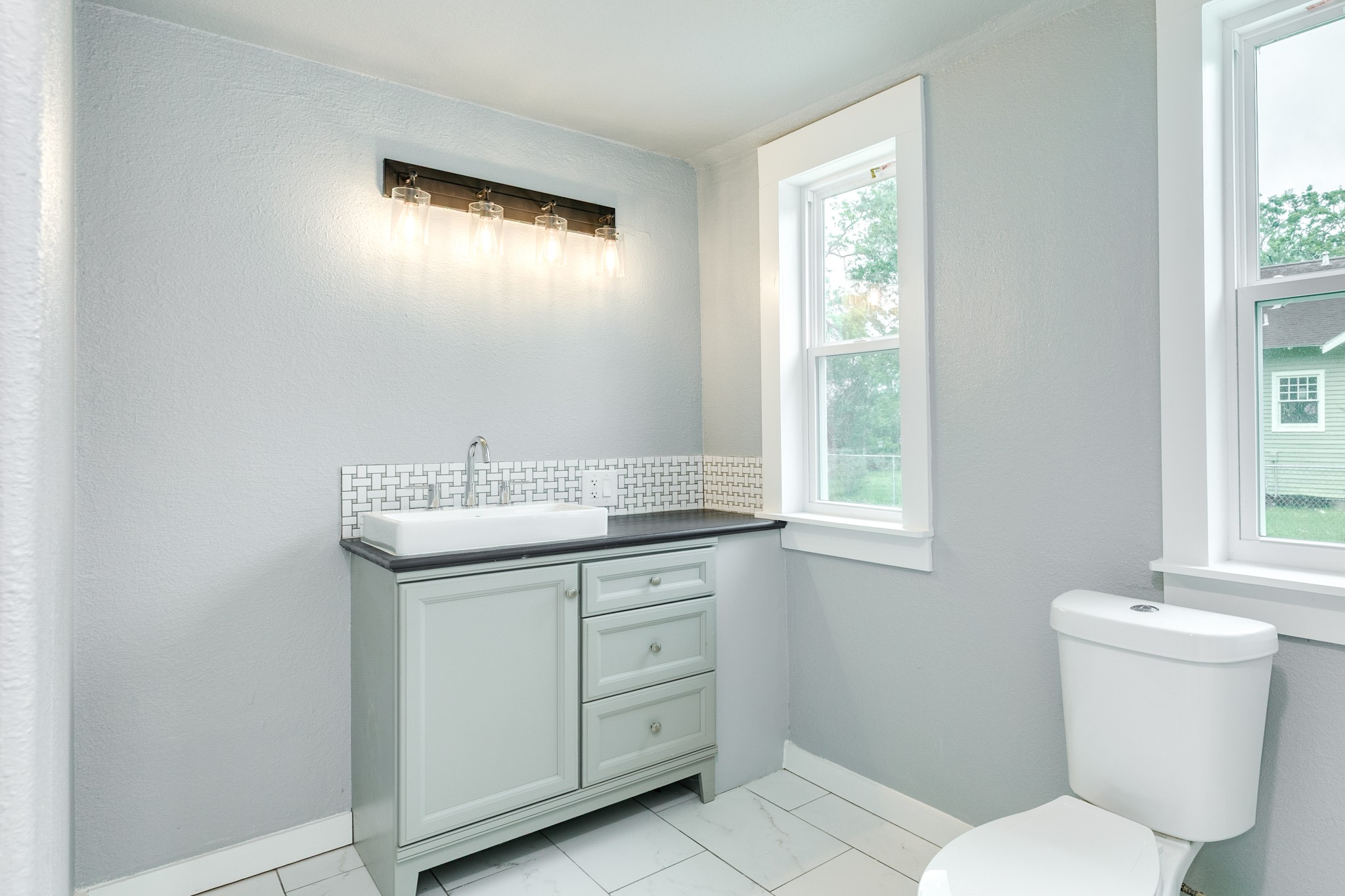 336 North Rockisland Street Angleton, TX 77515 - Photo 20 of 32 a bathroom with a toilet sink and mirror