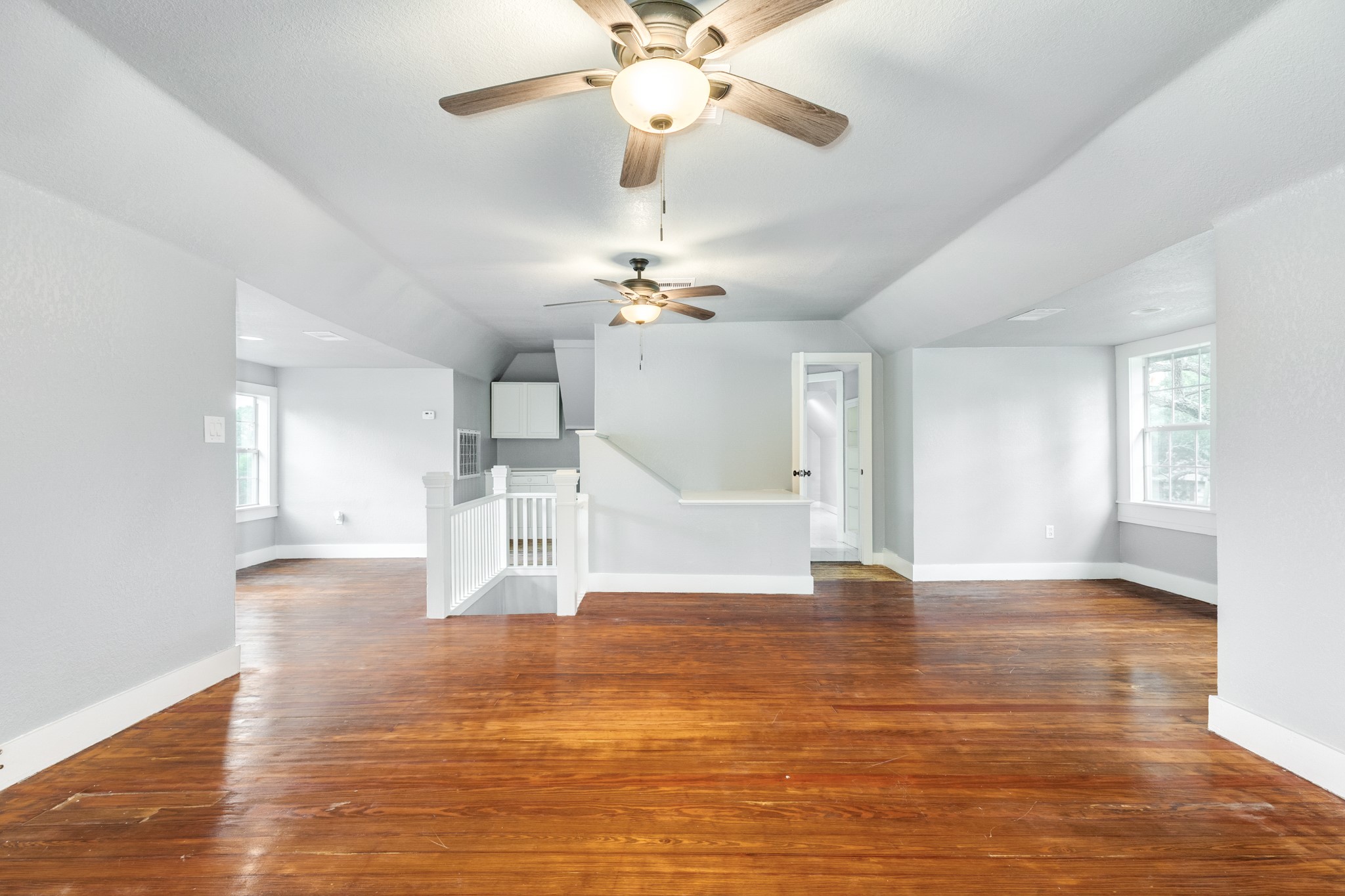336 North Rockisland Street Angleton, TX 77515 - Photo 24 of 32 a view of an empty room with wooden floor and a ceiling fan