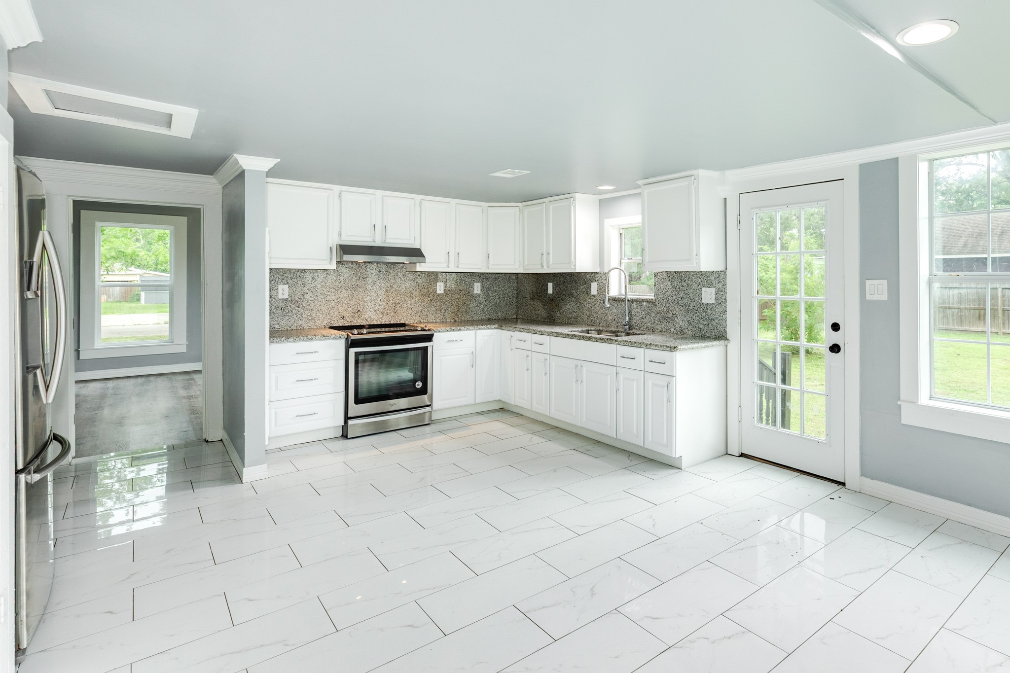 336 North Rockisland Street Angleton, TX 77515 - Photo 3 of 32 a kitchen with stainless steel appliances a sink a stove a refrigerator and cabinets