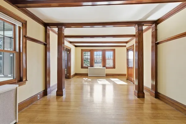 a view of an entryway with wooden floor and door
