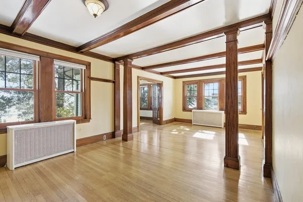 a view of an entryway with wooden floor and windows