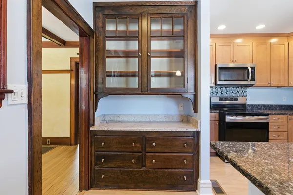 a kitchen with granite countertop a stove and a microwave