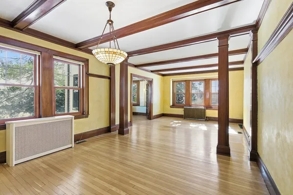 a view of an entryway with wooden floor and door