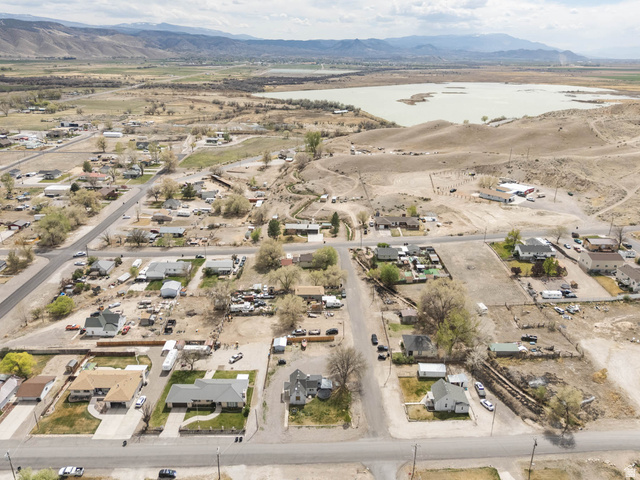 197 West 100 South Redmond, UT 84652 - Photo 37 of 41 Aerial perspective of suburban area with a water and mountain view and a desert landscape