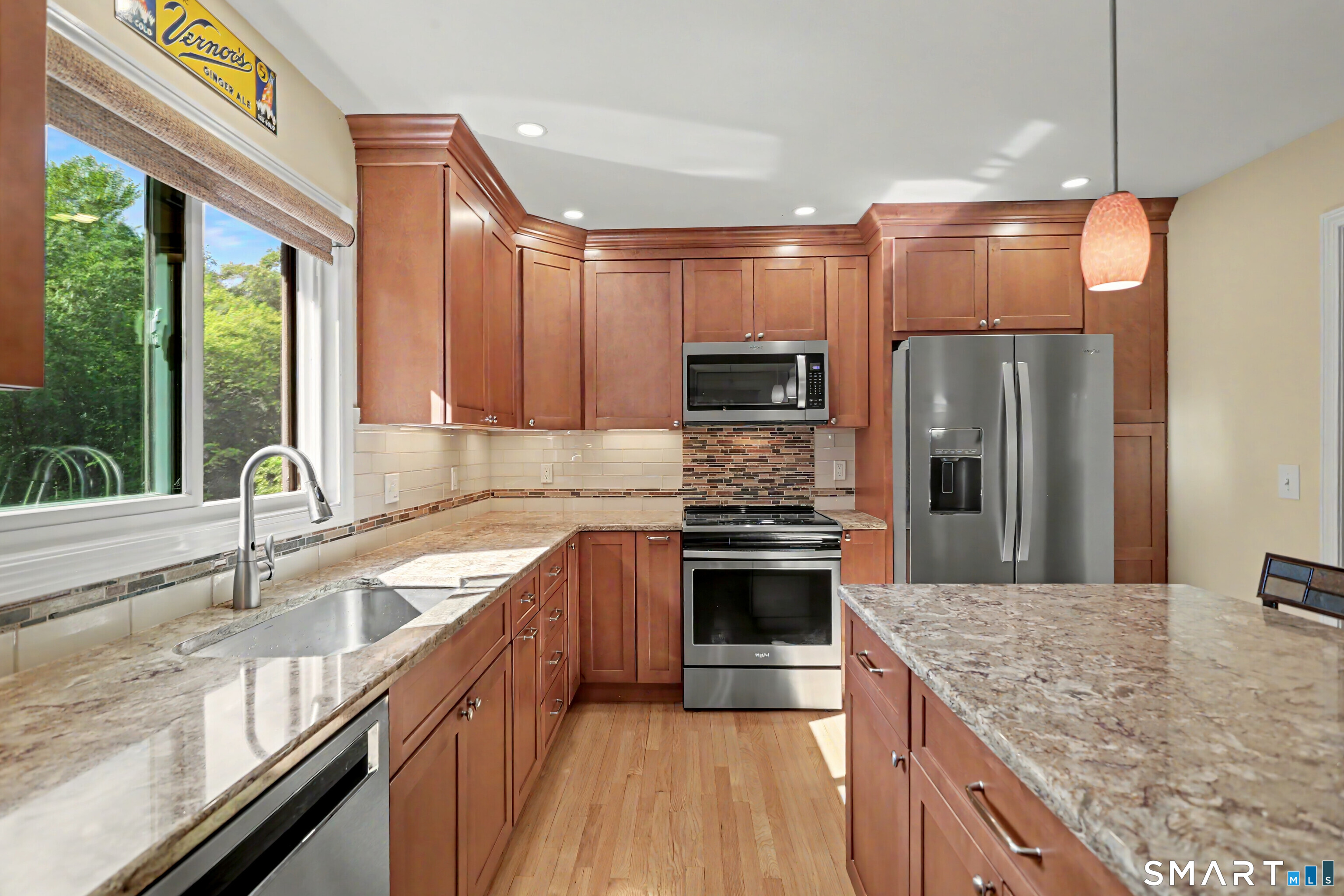 632 Wheelers Farm Road Orange, CT 06477 - Photo 9 of 39 a kitchen with stainless steel appliances granite countertop a sink stove and refrigerator