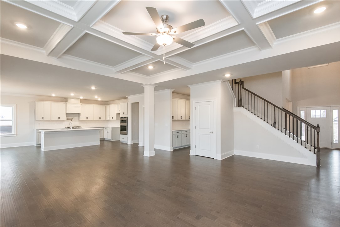 220 Holly Br Road Piedmont, SC 29673 - Photo 11 of 33 This expansive open-concept living space features hardwood floors, a coffered ceiling, and a modern kitchen.