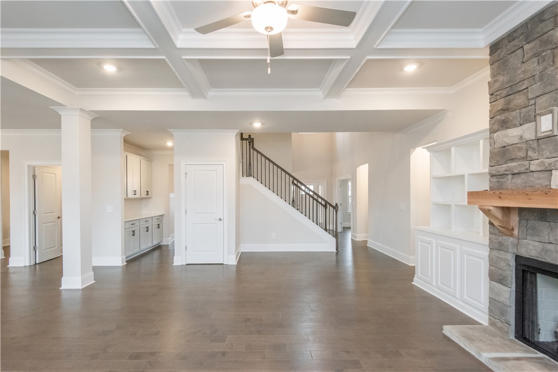 220 Holly Br Road Piedmont, SC 29673 - Photo 12 of 33 This expansive living space features a cozy fireplace and elegant coffered ceilings.