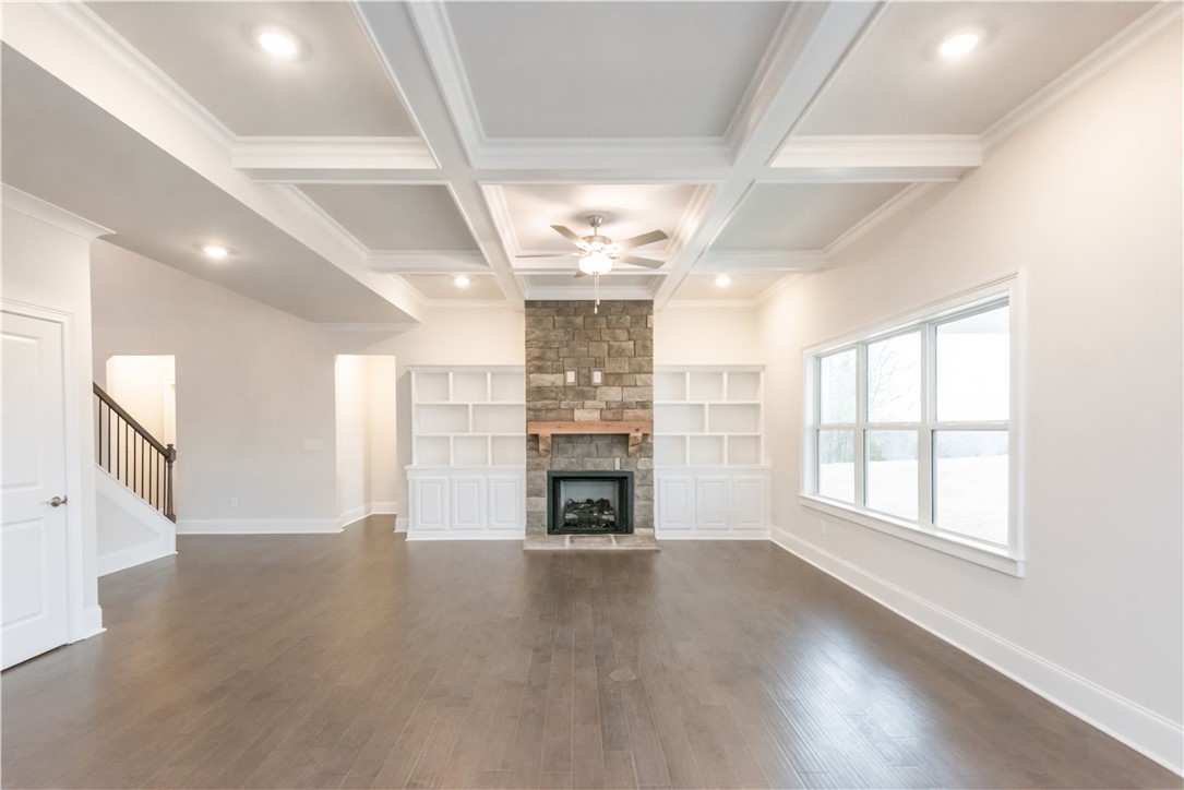 220 Holly Br Road Piedmont, SC 29673 - Photo 13 of 33 This expansive living area features elegant coffered ceilings and rich hardwood flooring.
