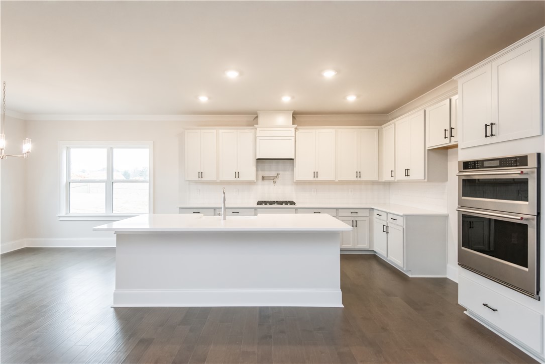 220 Holly Br Road Piedmont, SC 29673 - Photo 15 of 33 This bright kitchen features sleek appliances, an expansive island, and ample cabinetry for culinary pursuits.