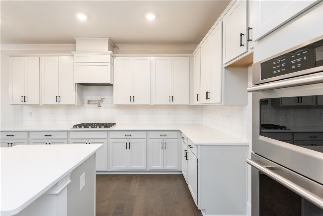 220 Holly Br Road Piedmont, SC 29673 - Photo 16 of 33 This modern kitchen features pristine countertops and ample cabinetry for culinary pursuits.