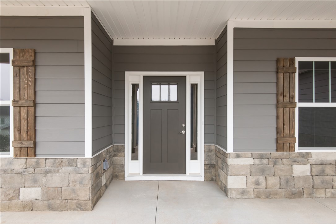 220 Holly Br Road Piedmont, SC 29673 - Photo 2 of 33 This charming entrance features durable siding and a sturdy stone foundation, offering enduring curb appeal.