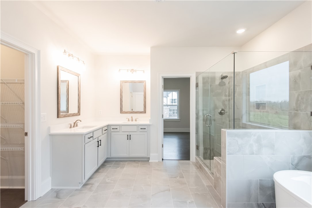220 Holly Br Road Piedmont, SC 29673 - Photo 26 of 33 This spacious bathroom offers dual vanities and a contemporary shower for daily comfort.