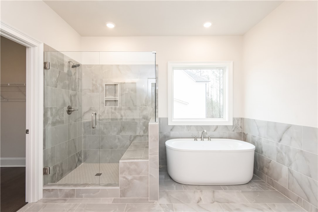 220 Holly Br Road Piedmont, SC 29673 - Photo 27 of 33 This serene bath offers a spacious walk-in shower and a freestanding soaking tub.