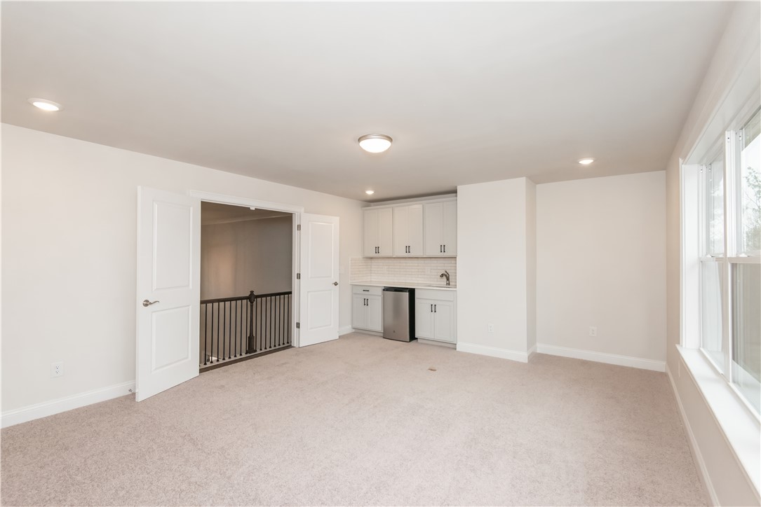 220 Holly Br Road Piedmont, SC 29673 - Photo 32 of 33 This versatile loft area features a convenient wet bar and ample natural light, ideal for entertaining.