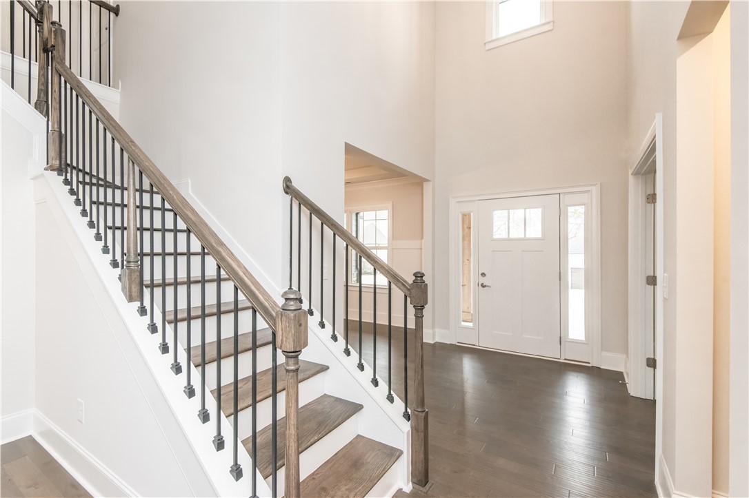 220 Holly Br Road Piedmont, SC 29673 - Photo 4 of 33 The bright entrance features a sweeping staircase and rich wood floors.