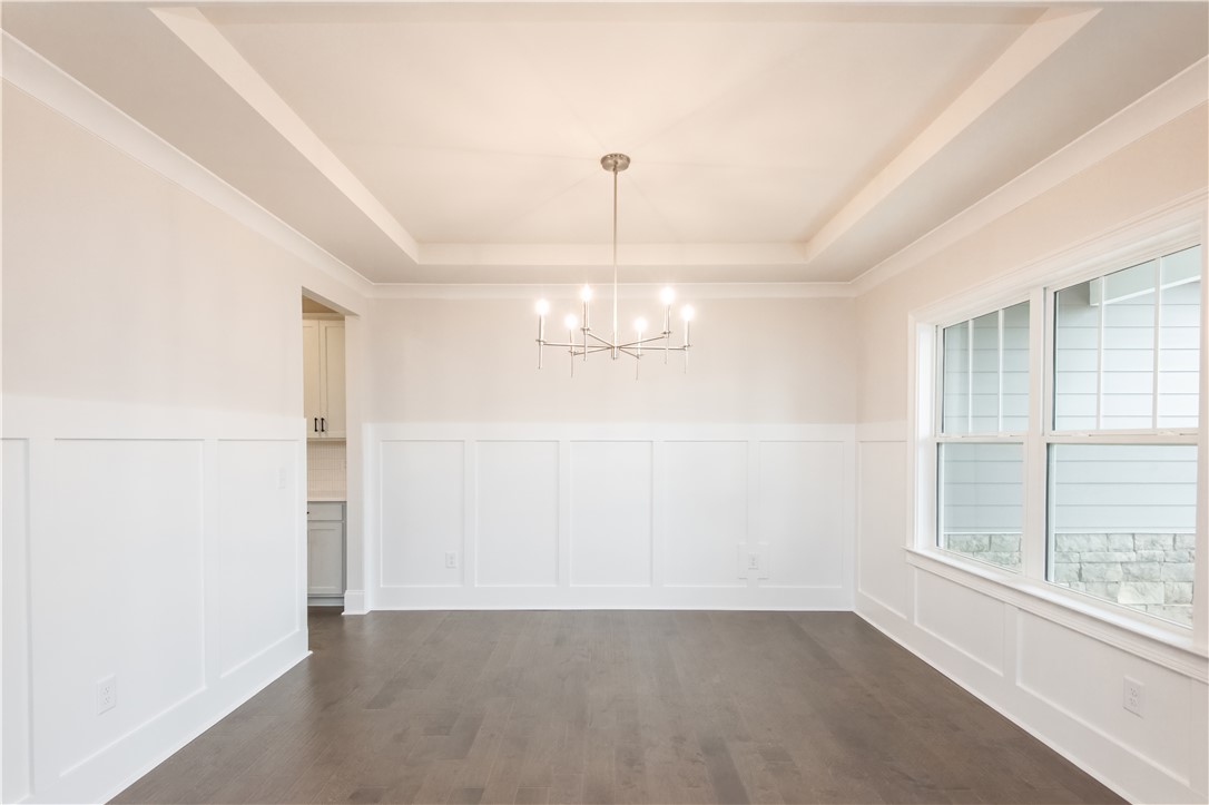 220 Holly Br Road Piedmont, SC 29673 - Photo 5 of 33 This bright dining room features rich wood flooring and elegant ceiling details, ready for memorable gatherings.