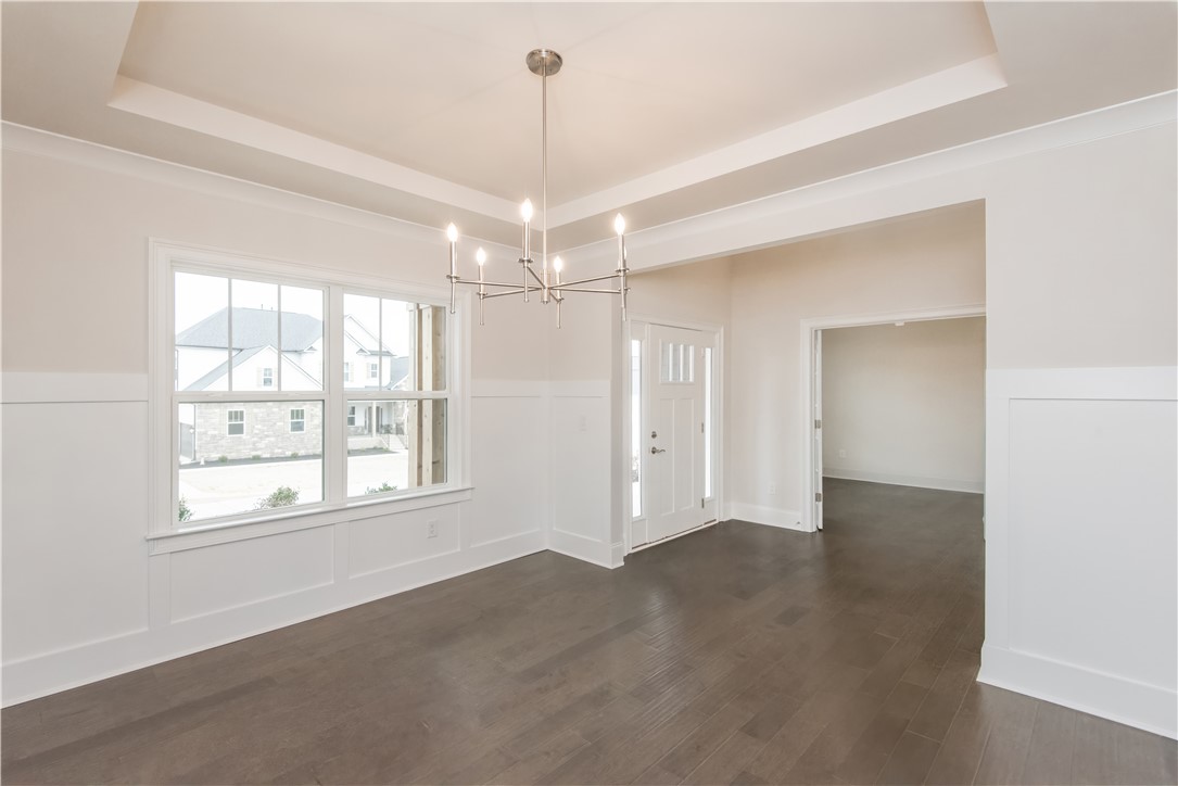 220 Holly Br Road Piedmont, SC 29673 - Photo 6 of 33 Bright and airy interior with elegant wood flooring and a modern chandelier.