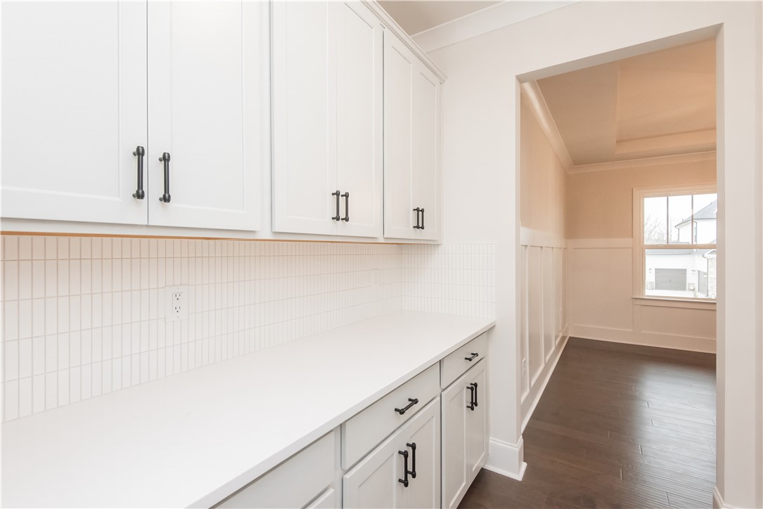 220 Holly Br Road Piedmont, SC 29673 - Photo 8 of 33 This bright space features sleek cabinetry, pristine countertops, and rich hardwood flooring, offering modern living.