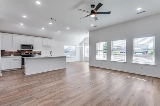 a view of a kitchen with a sink and a window