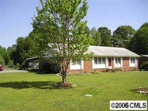 1217 Neal Street Monroe, NC 28112 - Photo 1 of 8 a front view of a house with a garden