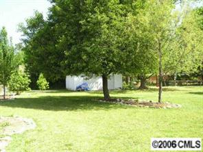 1217 Neal Street Monroe, NC 28112 - Photo 5 of 8 a view of swimming pool with a big yard and large trees