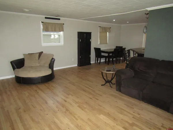 a living room with furniture and kitchen view