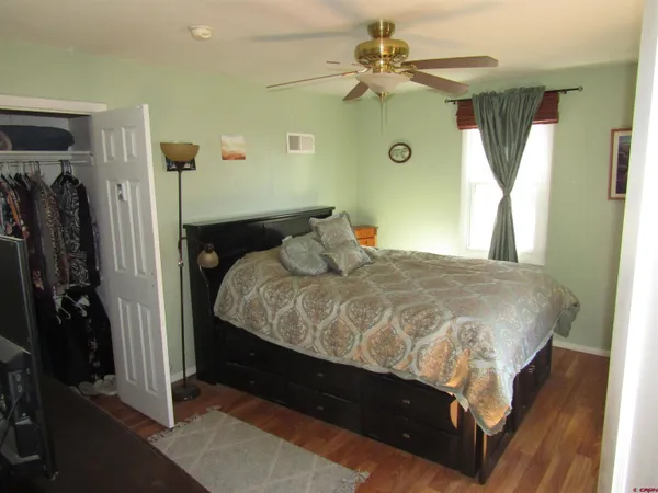 a bedroom with a bed dresser and a window