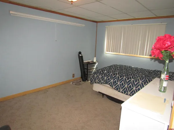 a bed sitting in a bedroom next to a window