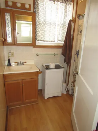a utility room with a sink a window and a washer