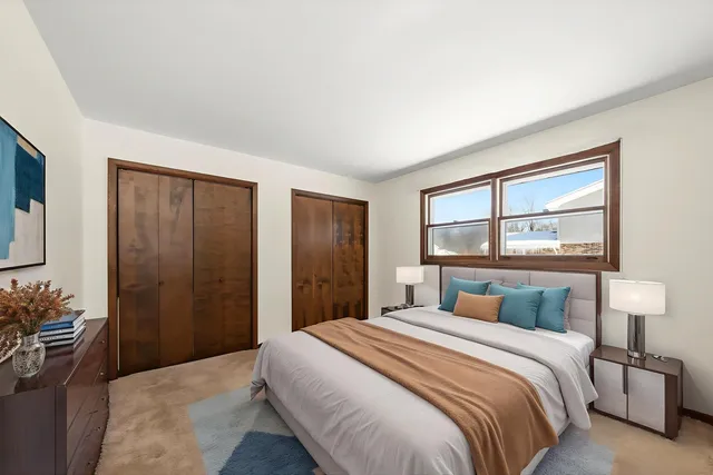 a bedroom with a large bed and a window