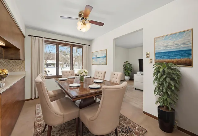 a dining room with furniture window and wooden floor