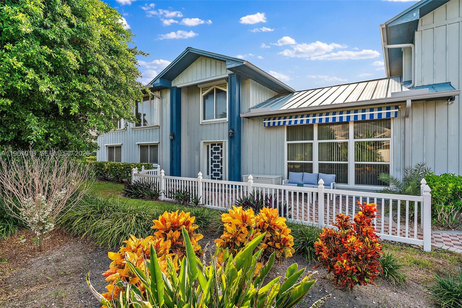 219 Colony Road Jupiter Inlet Colony, FL 33469 - Photo 3 of 33 a front view of a house with a garden