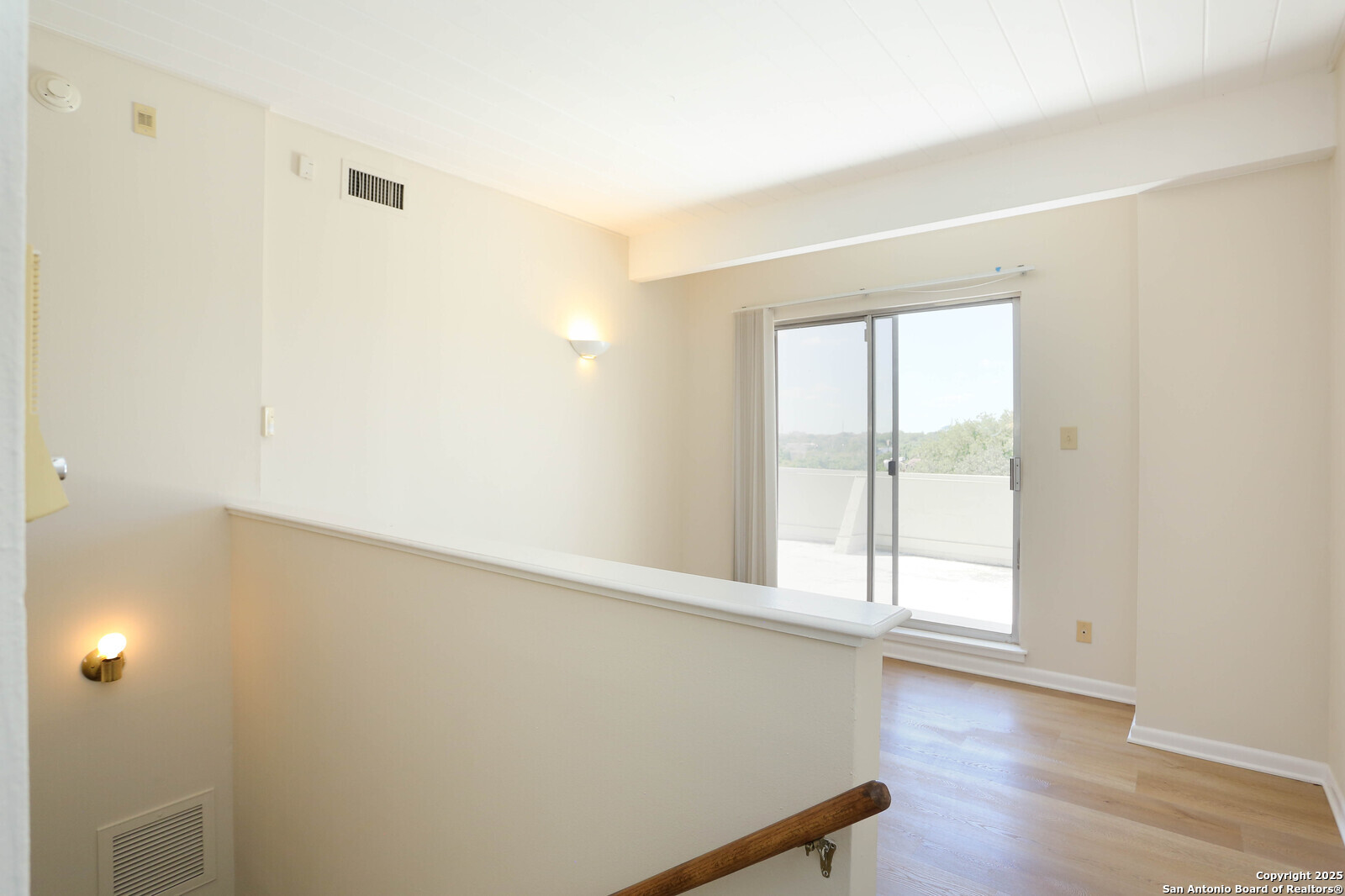 3102 Eisenhauer Road, Unit B16 San Antonio, TX 78209 - Photo 23 of 31 an empty room with wooden floor and windows