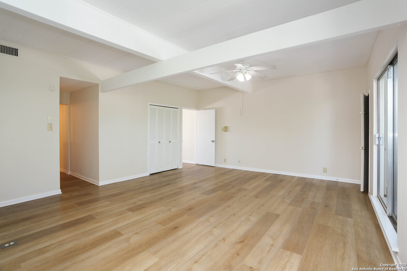 3102 Eisenhauer Road, Unit B16 San Antonio, TX 78209 - Photo 27 of 31 a view of an empty room with wooden floor and a window